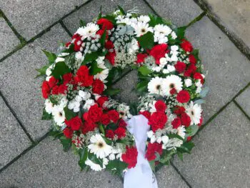 rot weißer Trauerkranz mit roten Rosen